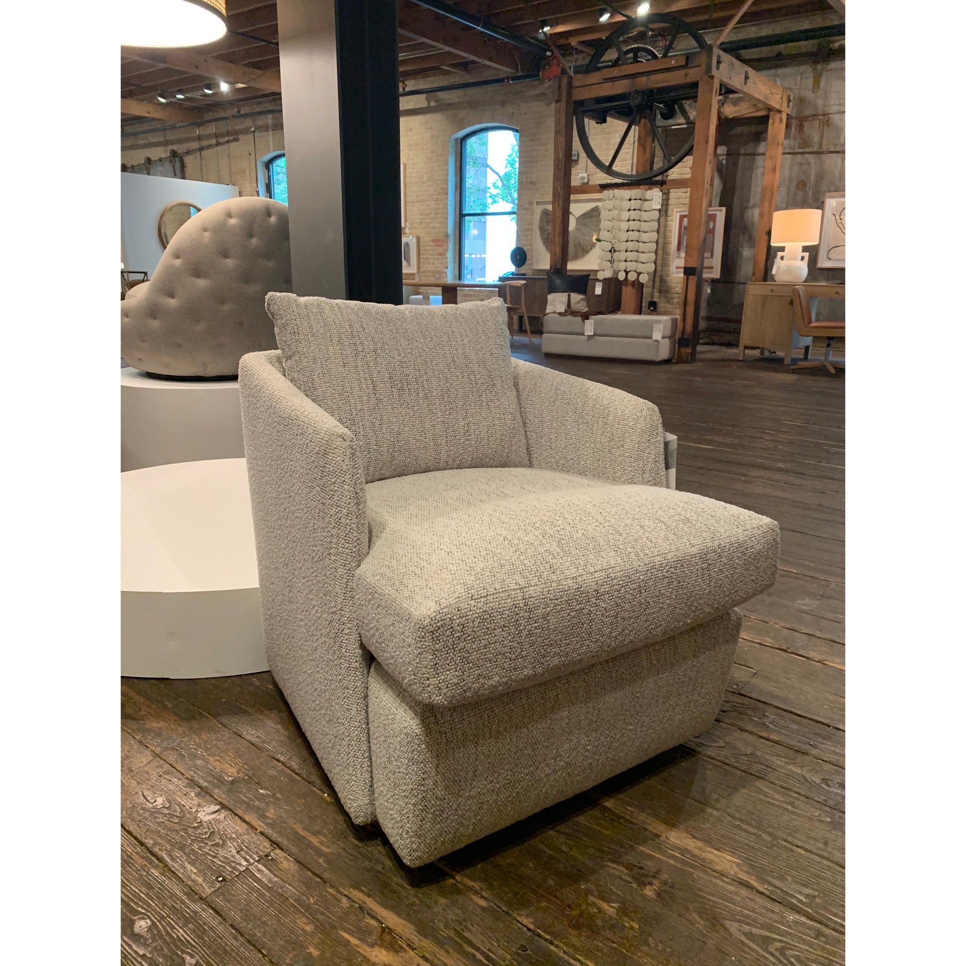 This Whittaker Swivel Chair - Merino Cotton is a comfortable classic. Atop a 360-degree swivel base, well-tailored cotton seating provides a beautifully simple place to perch in style, with feather-blend cushioning for total relaxation -- the perfect chair for a baby room, living room, or other area.   Overall Dimensions: 28.75"w x 35.00"d x 35.50"h