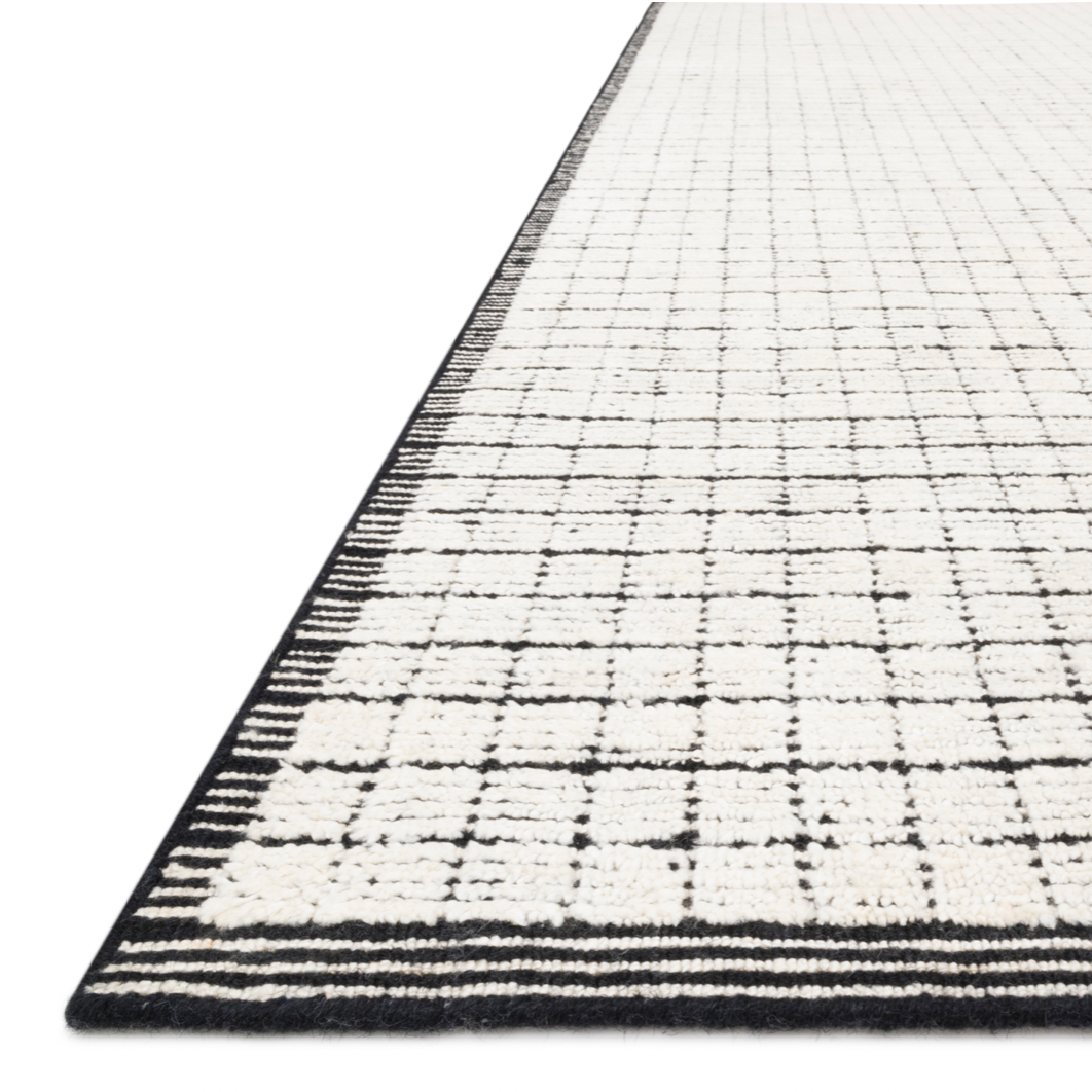 Modern and refined, the Beverly Ivory/Black rug from Loloi is hand-loomed by master artisans of viscose and wool pile. Clean lines and minimalist hues allow you to layer Beverly into any room.  Hand Loomed 69% Viscose | 31% Wool BEV-01 Ivory / Black