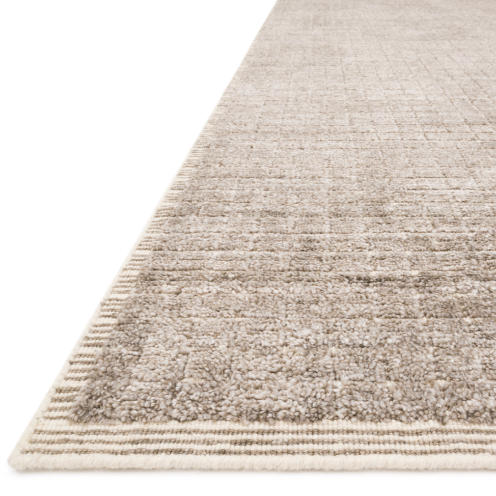 Modern and refined, the Beverly Stone rug by Loloi is hand-loomed by master artisans of viscose and wool pile. Clean lines and minimalist hues allow you to layer Beverly into any room.  Hand Loomed 45% Viscose | 26% Wool | 20% Cotton | 7% Polyester | 2% Other Fibers BEV-01 Stone