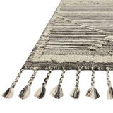 A new take on Moroccan style rugs, the Iman Collection is hand-knotted of 100% wool pile by skilled artisans in India. The surface features linear and braided details, creating tonal variations that make each piece unique. Plus, each design is finished with playful fringe.  Hand Knotted 100% Wool Pile IMA-01 Ivory / Charcoal