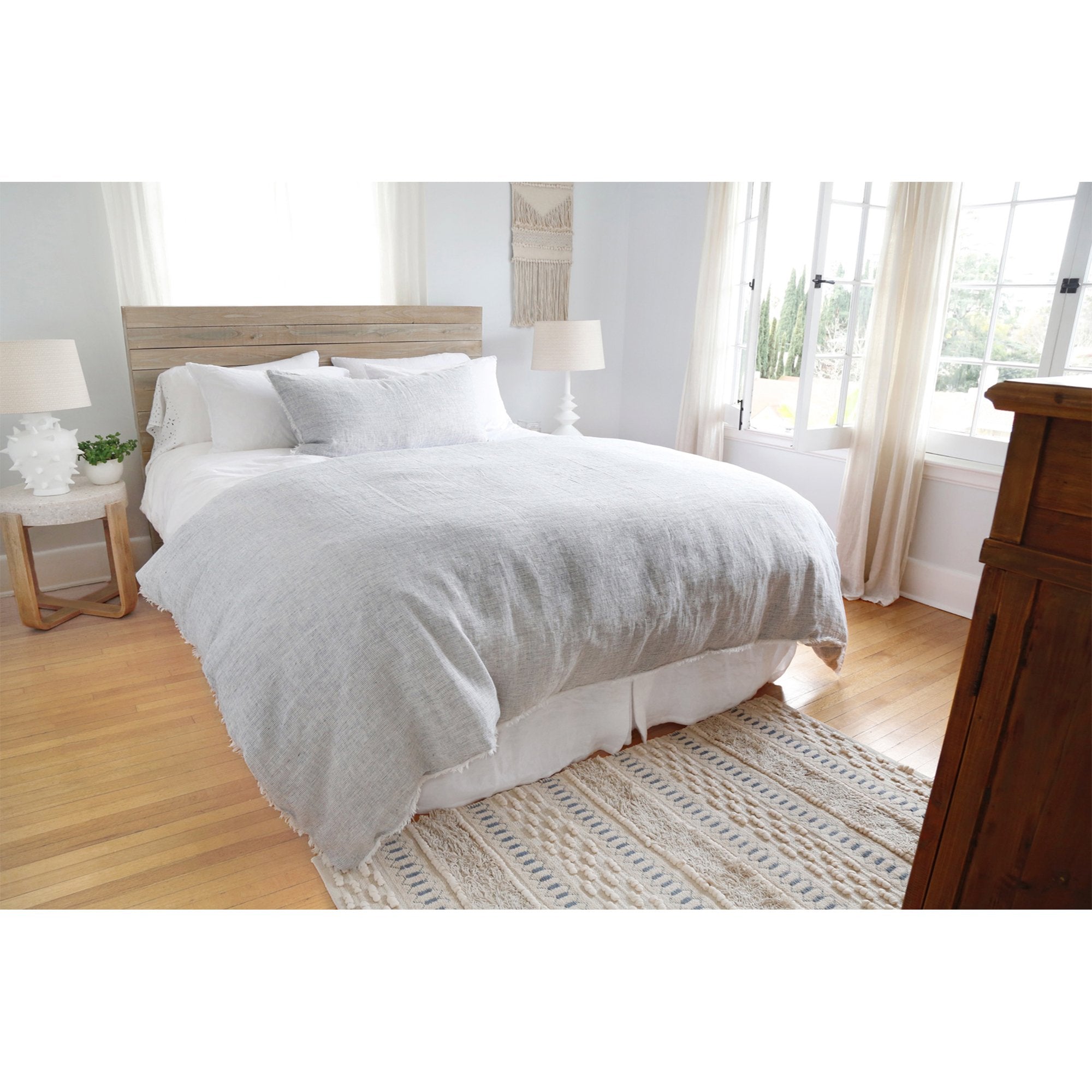 Subtle frayed edges of soft linen add a dash of unexpected detail to this Logan Duvet Collection Navy by Pom Pom at Home. Woven with two different colored yarns for a heathered effect, the duvet cover and shams feature shell button closures.  Inserts sold separately 100% linen Shell-button closure Machine wash cold; tumble dry low; warm iron as needed. Do not bleach