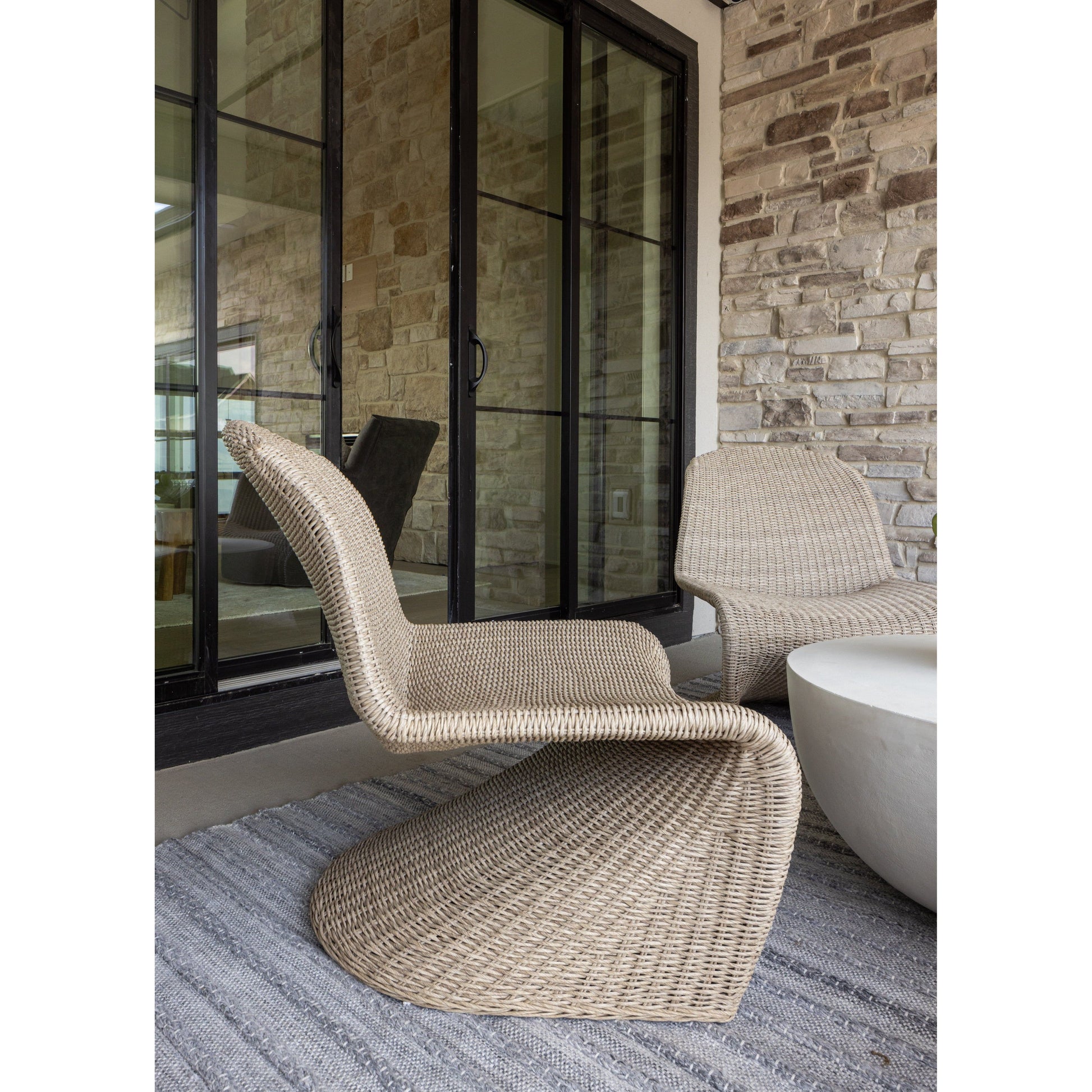 This Portia Outdoor Occasional Chair - Vintage White features a unique shape for comfortable seating. Finished in a vintage white, all-weather wicker makes this the perfect chair for indoors or out. Amethyst Home provides interior design, new home construction design consulting, vintage area rugs, and lighting in the Alpharetta metro area.