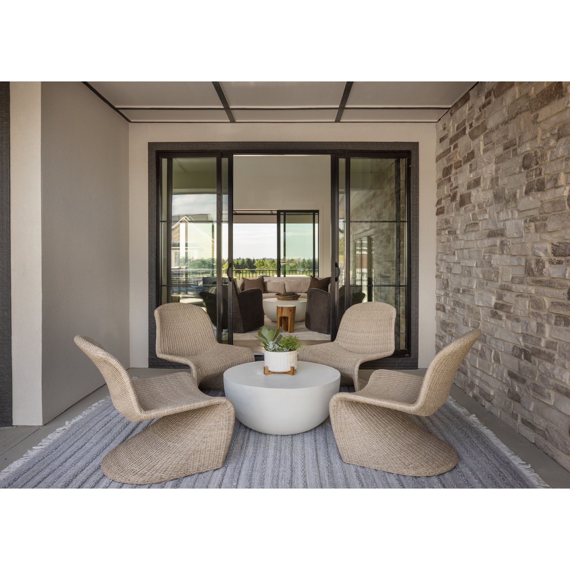 This Portia Outdoor Occasional Chair - Vintage White features a unique shape for comfortable seating. Finished in a vintage white, all-weather wicker makes this the perfect chair for indoors or out. Amethyst Home provides interior design, new home construction design consulting, vintage area rugs, and lighting in the Washington metro area.
