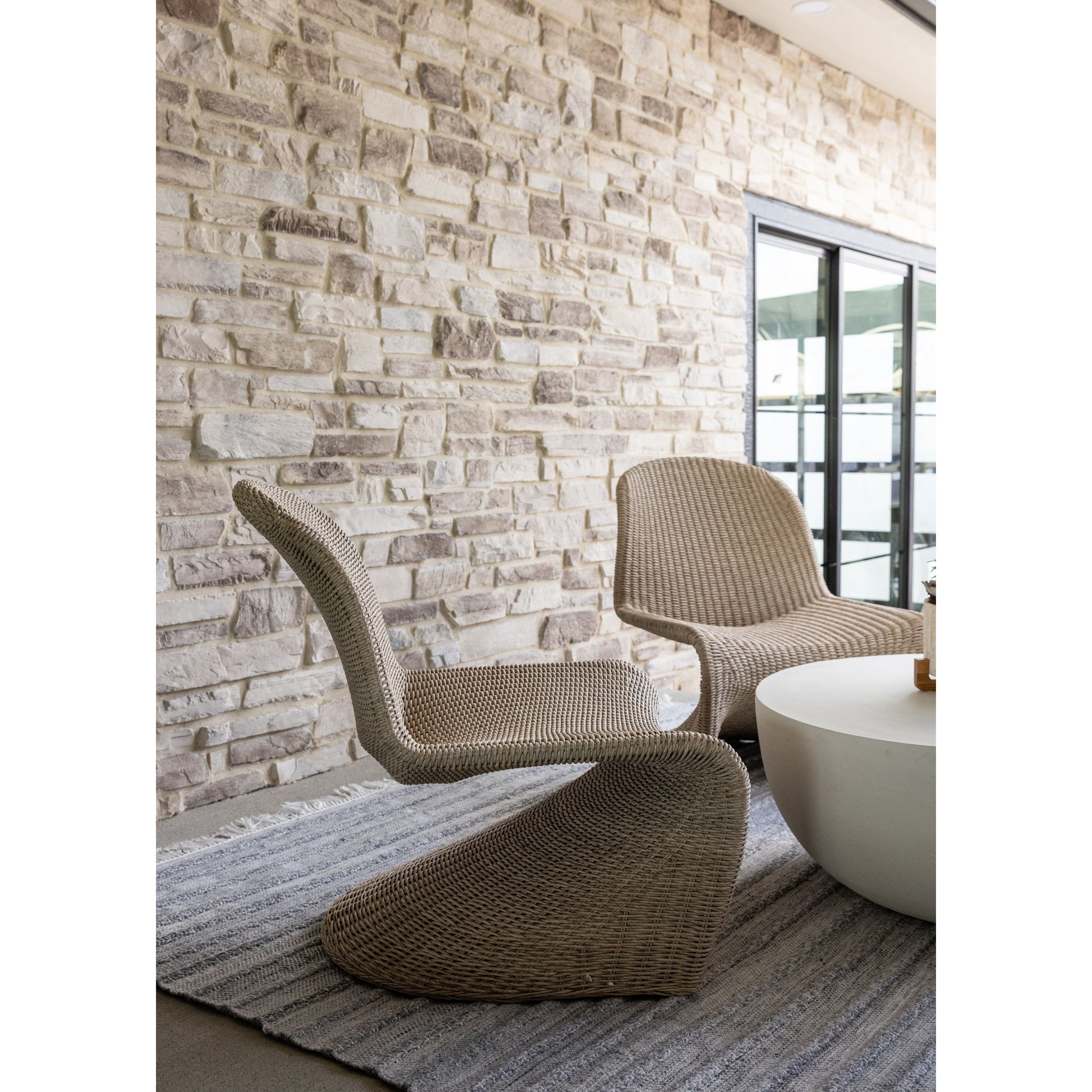 This Portia Outdoor Occasional Chair - Vintage White features a unique shape for comfortable seating. Finished in a vintage white, all-weather wicker makes this the perfect chair for indoors or out. Amethyst Home provides interior design, new home construction design consulting, vintage area rugs, and lighting in the Nashville metro area.